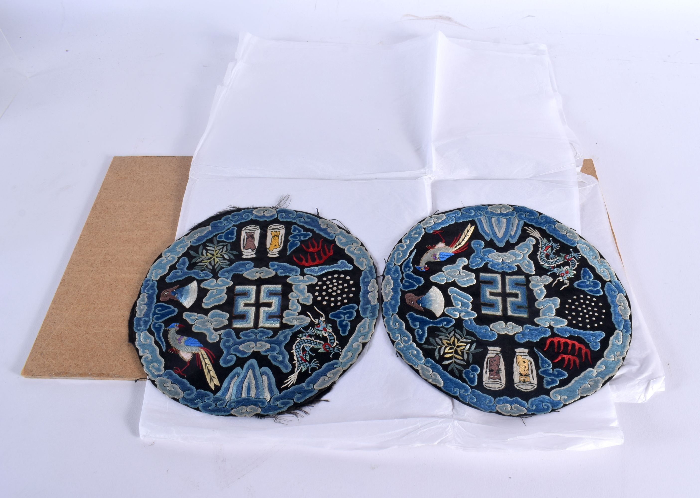 A RARE PAIR OF EARLY 20TH CENTURY CHINESE SILK ROUNDELS depicting cats and symbols. 19 cm diameter.