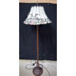 A metal lampstand with a large Tiffany style shade 164 cm.