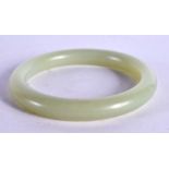 A CHINESE CARVED GREEN JADE BANGLE 20th Century. 5.5 cm diameter.