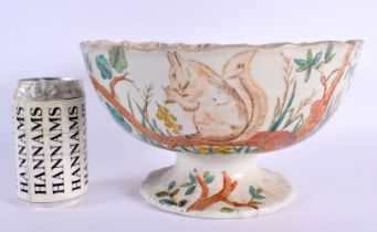 A LARGE AND UNUSUAL VICTORIAN POTTERY PEDESTAL BOWL printed with squirrels. 22 cm x 14 cm.