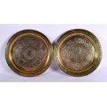 A PAIR OF 19TH CENTURY MIDDLE EASTERN SILVER INLAID DISHES decorated with scripture and motifs. 23 c