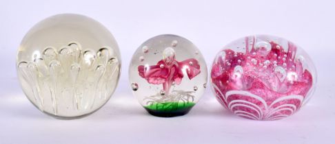 THREE GLASS PAPERWEIGHTS. Largest 9.25 cm wide. (3)