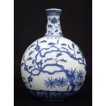 A Chinese porcelain blue and white flask decorated with foliage 24 cm.