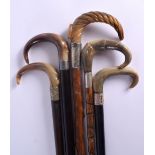 FIVE 19TH CENTURY MIDDLE EASTERN CARVED RHINOCEROS HORN WALKING CANES. 90 cm long. (5)