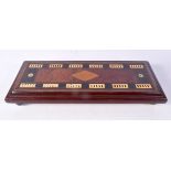 AN ANTIQUE CARVED WOOD AND IVORINE GAMING BOARD. 37 cm x 15 cm.
