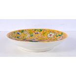 A Chinese porcelain Famille Jeune dish decorated with birds 22 cm diameter.