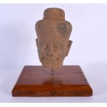 A SOUTH EAST ASIAN CARVED STONE CAMBODIAN BUDDHA HEAD. 24 cm x 16 cm.