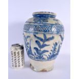 AN EARLY MIDDLE EASTERN PERSIAN BLUE AND WHITE POTTERY VASE painted with foliage and vines. 27 cm x