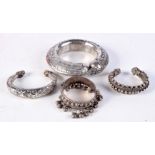 FOUR MIDDLE EASTERN YEMENI SILVER BANGLES. 328 grams. Largest 6.75 cm wide. (4)