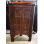 AN ANTIQUE GOTHIC REVIVAL STANDING CORNER CUPBOARD. 147 cm x 93 cm x 53 cm.