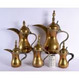 A RARE SET OF FIVE 19TH CENTURY MIDDLE EASTERN OMANI TYPE BRONZE EWERS with large spouts. Largest 42