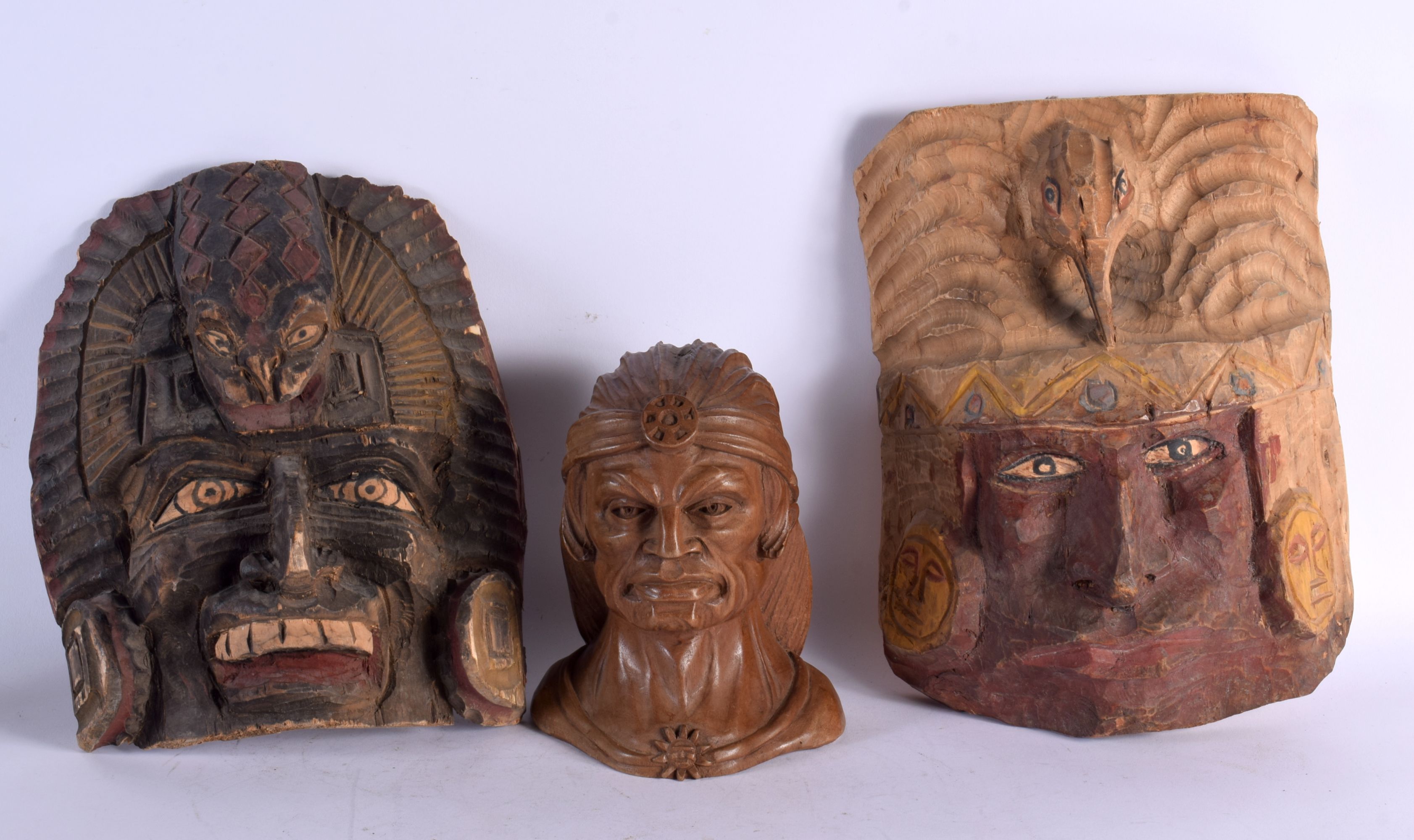 TWO VINTAGE TRIBAL WOOD MASKS and a smaller bust. Largest 36 cm x 18 cm. (3)