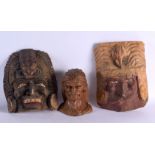 TWO VINTAGE TRIBAL WOOD MASKS and a smaller bust. Largest 36 cm x 18 cm. (3)