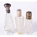 THREE SILVER MOUNTED SCENT BOTTLES. Largest 10.7cm x 3.6cm x 2.3cm (3)