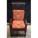 A JACOBEAN AND LATER OAK ARM CHAIR of good colour, with red cushions. 126 cm x 62 cm x 66 cm.