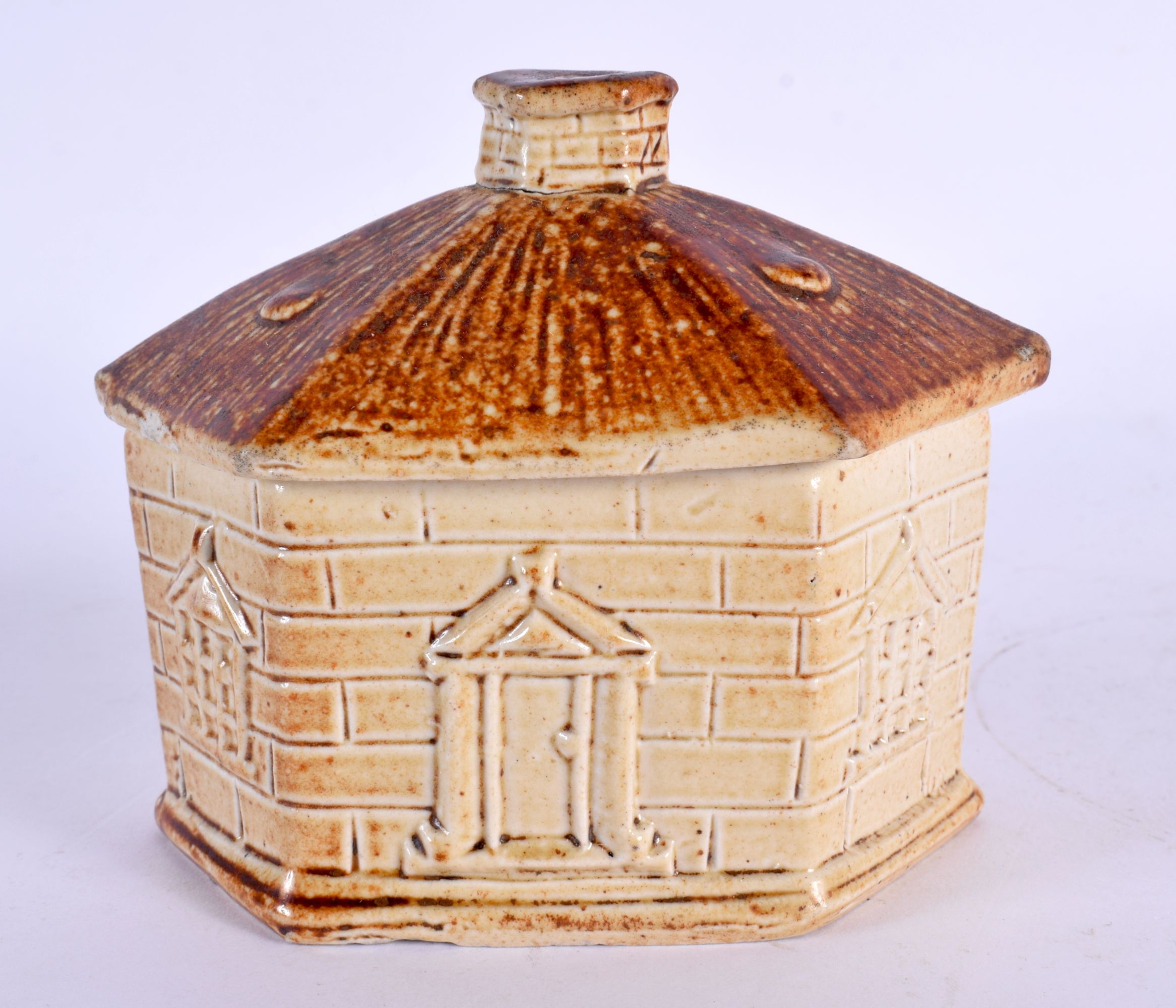 A RARE 19TH CENTURY ENGLISH SALT GLAZED BOX AND COVER formed as a house. 11 cm x 9 cm.