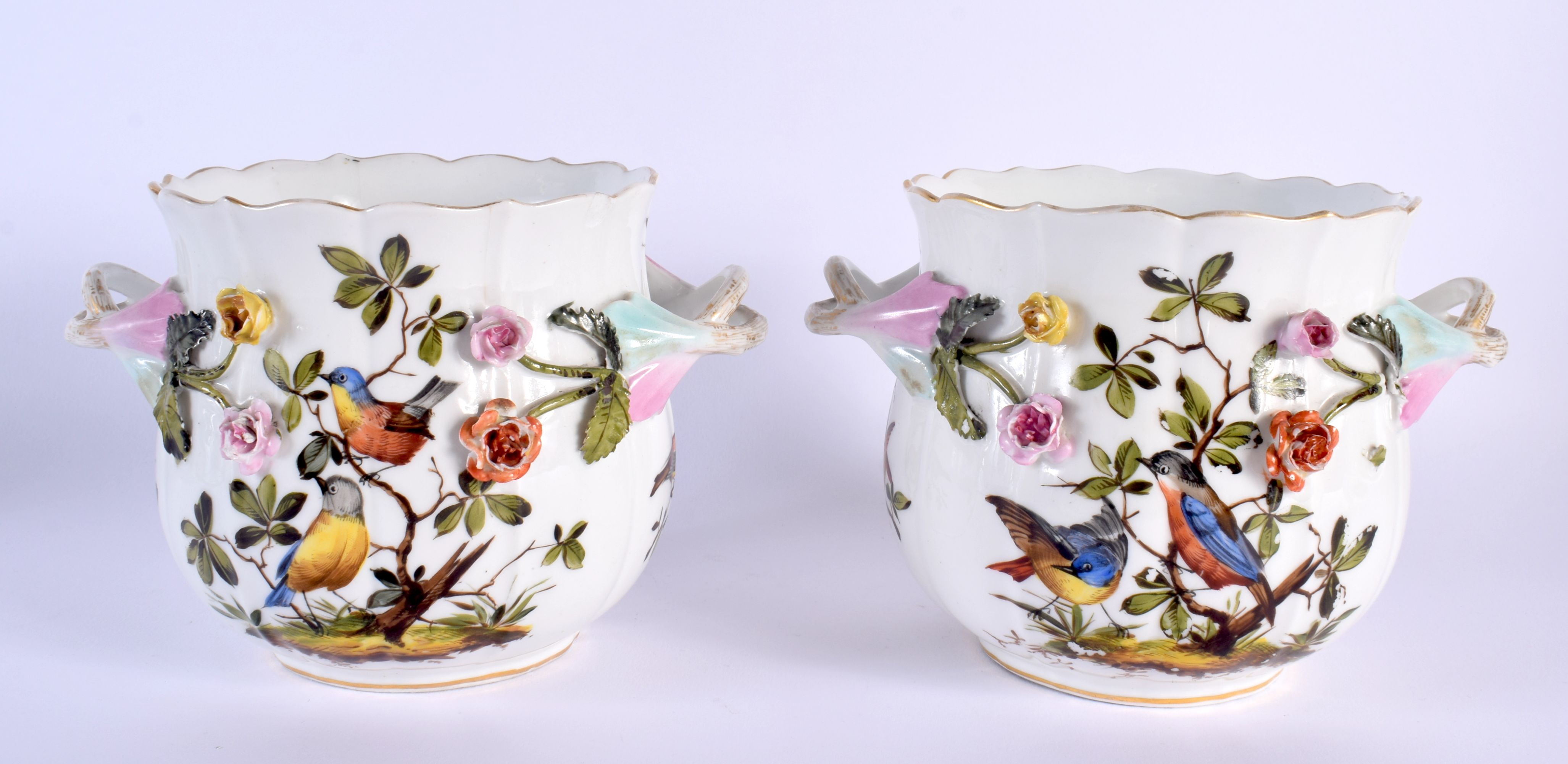 A PAIR OF 19TH CENTURY GERMAN TWIN HANDLED ENCRUSTED PORCELAIN JARDINIERES painted with birds. 17 cm