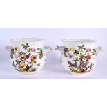 A PAIR OF 19TH CENTURY GERMAN TWIN HANDLED ENCRUSTED PORCELAIN JARDINIERES painted with birds. 17 cm