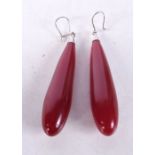 A PAIR OF VINTAGE CHERRY AMBER TYPE EARRINGS. 9.5 cm long.