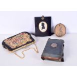 An antique handbag together with a framed silouette, framed etching and a leather bound bible with a