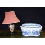 A JAPANESE SATSUMA LAMP and a blue and white foot bath planter. Largest 48 cm x 34 cm. (2)