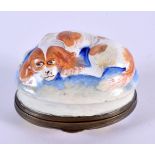 A RARE 18TH CENTURY BATTERSEA ENAMEL PILL BOX AND COVER modelled with a recumbant spaniel. 4.5 cm x