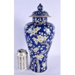 A LARGE EARLY 20TH CENTURY JAPANESE MEIJI PERIOD MIDNIGHT BLUE VASE AND COVER painted with flowers.