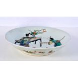 A Chinese porcelain Famille Verte dish decorated with figures 22 cm diameter.