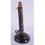 AN EARLY CONTINENTAL IRON PIG TAIL CANDLESTICK. 22 cm high.