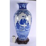 A LARGE 19TH CENTURY JAPANESE MEIJI PERIOD BLUE AND WHITE VASE upon an antique Chinese stand. 65 cm