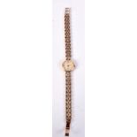 A 9CT GOLD ACCURIST WRISTWATCH with 9ct gold strap. 22 grams. 2 cm wide inc crown.