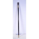 An Indian ebonised wood sword stick with carved bone handle and embossed brass fittings 90 cm.