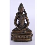 A 19TH CENTURY INDIAN SOUTH EAST ASIAN BRONZE FIGURE OF AN EROTIC DEITY modelled as a buddha. 11.75