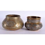 TWO 19TH CENTURY MIDDLE EASTERN SILVER INLAID CENSERS decorated with calligraphy. Largest 11 cm wide