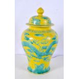 A Chinese porcelain yellow ground jar and cover decorated in relief with a dragon ,25cm.