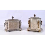 A middle Eastern metal tea caddy with embossed panels and brass fittings together with another simil