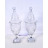 A pair of 19th Century cut glass urns and covers 35 cm (2)