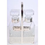 A SILVER PLATED CUT GLASS TWIN DECANTER SET with labels. 32 cm x 15 cm.