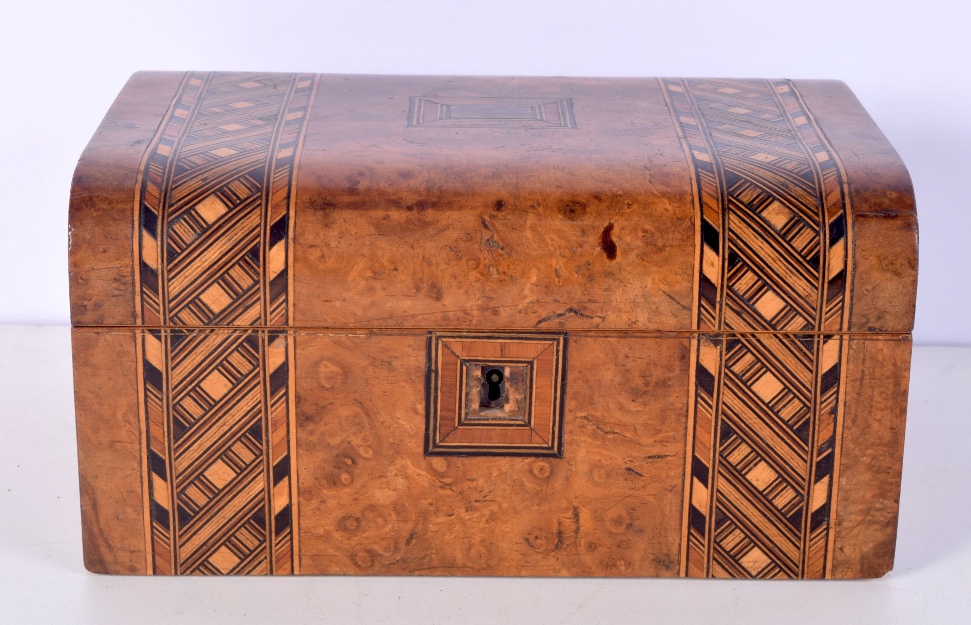 A burr wood and inlaid box with a central unmarked brass plaque. 12 x 25 x 17cm.