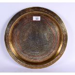 A LARGE 19TH CENTURY MIDDLE EASTERN SILVER INLAID DISH decorated with calligraphy and motifs. 33 cm