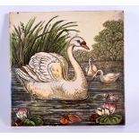 A CHARMING ANTIQUE POTTERY TILE decorated with swans. 15 cm square.