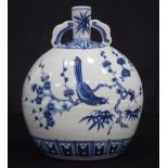 A Chinese porcelain blue and white twin handled flask decorated with birds in foliage 26cm.