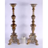 A LARGE PAIR OF ANTIQUE CONTINENTAL BRASS CANDLESTICKS. 58 cm high.