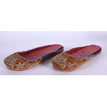 A PAIR OF 19TH CENTURY CHINESE SILKWORK EMBROIDERED SHOES Qing. 22 cm long.