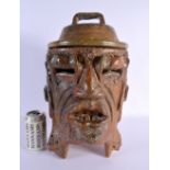 AN UNUSUAL SOUTH AMERICAN POTTERY BURNING FIGURAL MASK HEAD JAR AND COVER decorated with motifs. 42