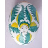 A TURKISH OTTOMAN ARMENIAN EGG painted with figures. 9 cm x 6 cm.