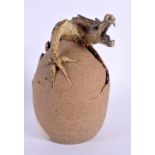 A CHARMING BLADON POTTERY GROTESQUE HATCHING DRAGON EGG SCULPTURE. 20 cm high.