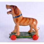 A VINTAGE FOLK ART CARVED WOOD PULL ALONG DOG. 24 cm x 16 cm.