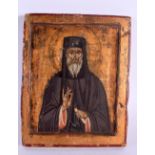 AN ANTIQUE RUSSIAN POLYCHROMED WOOD ICON. 23 cm x 18 cm.