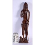 AN ARTS AND CRAFTS CARVED WOOD FIGURE OF A SOLDIER modelled standing upon a lion. 45 cm high.